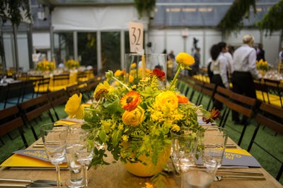 The floral arrangements, which contained a mix of greenery and blooms, reflected the colors of the dining table.