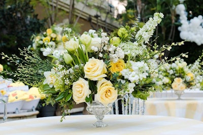 Every element of the party—including large floral centerpieces from Celio's Design—tied into the event's summery color scheme of yellow, white, and blue.