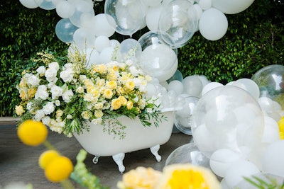 One of the more glamorous details of the event was a vintage bathtub-turned-flower installation. White and clear balloons spilled out of it, designed to look like bubbles flying everywhere.
