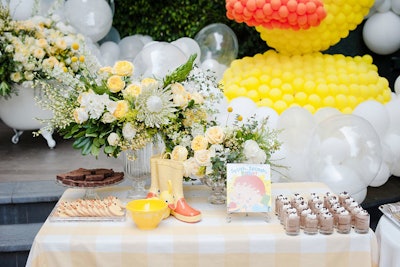 At another dessert table, rain boots and the book 'Splish Splash Baby' served as on-theme props.