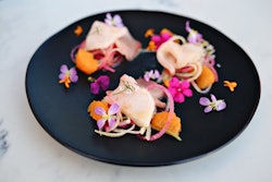 Hamachi crudo with cilantro-satsuma vinaigrette, radish, green onion, and red pepper with cilantro, citrus, and radish flowers, by Twenty/20 at the Sheraton Carlsbad Resort & Spa in Carlsbad, California.