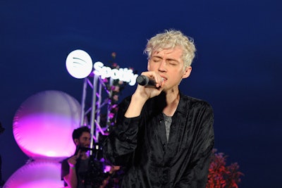 In theme with the title of Troye Sivan's new album, Bloom, fans were given roses and hydrangea, and floral notes and pink- and purple-hued lighting touched many aspects of the decor. Sivan performed stripped-down versions of four of his hit songs on a small outdoor stage.