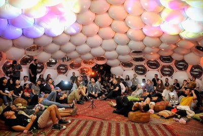 Inside the dome, which was decorated with patterned carpets and colorful cushions, Sivan shared anecdotes about his life and his creative process. Studio recordings from the album played as a light show projected images from the album on the dome ceiling.