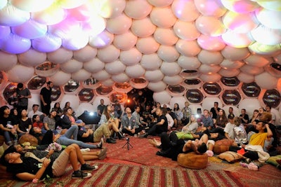 Inside the dome, which was decorated with patterned carpets and colorful cushions, Sivan shared anecdotes about his life and his creative process. Studio recordings from the album played as a light show projected images from the album on the dome ceiling.