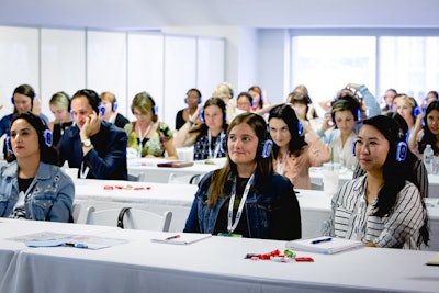 Quiet Events—which provides wireless headphone rentals for silent discos and has offices in Los Angeles, New York, San Francisco, Austin, London, Ottawa, and Tokyo—offered a meeting-friendly idea during the trade show's morning education sessions. Because four workshops were happening simultaneously, with only draping separating them, the headphones were used to ensure audiences could hear the sessions. Speakers spoke into a microphone, which fed directly into the headphones that had been provided for each attendee. The headphones can be customized with company logos, and they work as far away as 1,500 feet from the speaker and have a 12-hour battery life.