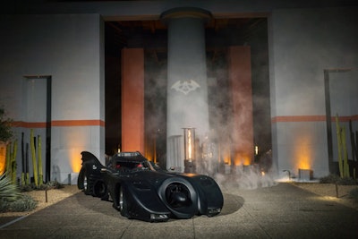 For a 40th birthday party in Napa Valley in March, Glow Events gave the superhero theme a black-tie makeover. To create a grand entrance for the client, the event firm worked with Los Angeles-based Star Car Central to secure the Batmobile from the 1989 Batman film. Inside the venue, a wine cave was transformed into the 'Batcave' with moody lighting, leather-accented table linens, tall candelabras, and trailing ivy.