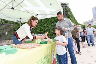 Actress and TV personality Vanessa Lachey hands out Fairlife chocolate milk and Otis Spunkmeyer cookies to visitors during the Chocolate Milk Happy Hour pop-up event in Millennium Park.