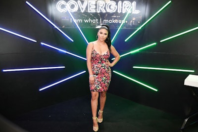 CoverGirl's booth included a photo backdrop made from angled neon lights that changed color.