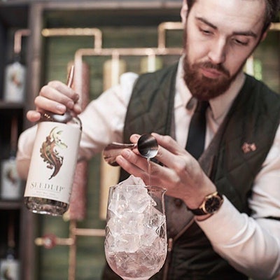 A bartender makes a cocktail using Seedlip Spice 94, which incorporates all spice, cardamom, oak, lemon, grapefruit, and cascarilla. The brand's other flavor, Garden 108, is made from peas, hay, spearmint, rosemary, and thyme.