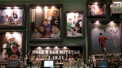 Fixed frames over the bar were filled with images of a young man’s dream come true.