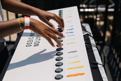Art installations are nothing new at music festivals, but Destination San Diego aimed to take it a step further by creating a living mural. Visitors could contribute to it throughout the day by pushing one of a series of buttons; depending on the color selected, a new stripe of paint was added.