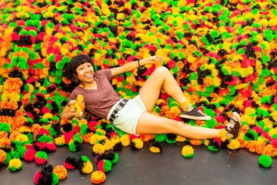 In a twist on the ball pit photo op, guests could lay in a pool of colorful Koosh balls, a popular ‘90s toy.