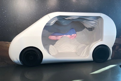 Snarkitecture created a self-driving car installation with a mixture of upholstery foam and wood. The installation was meant to reimagine a car interior by creating a monochromatic, topographic landscape, mirroring a cave. The 'car' was backed by a wall depicting a starry sky above a desert.