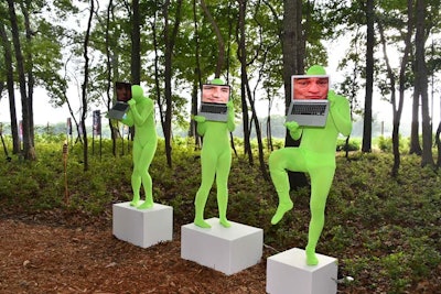Jörg Brinkmann's 'The Broad Gave Me My Face But I Can Pick Up My Own Nose' featured three performers clad in neon bodysuits hoisting MacBooks that displayed alternating famous faces like Sir Elton John, Mr. T, and President Donald Trump, which were choreographed to their movements.