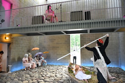 Inside the main building was a live collaborative installation between CocoRosie and Doug Wieselman (playing clarinet), entitled 'Lying Awake; Our Lady of the Flowers.' A chorus of women in white makeup performed an undulating free-form dance while men sat in row boats placed atop the stone-covered floor. A horn section played on the balcony.