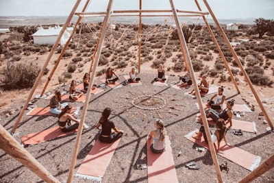 Yoga in the desert under our Bare TipiMarqui