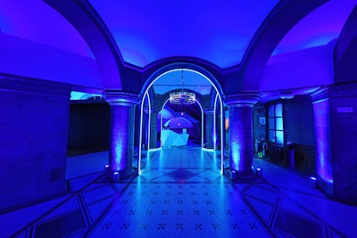 The inside of the venue was lighted in bold, blue lighting. Adding to the sleek aesthetic was a transparent, circular chandelier that welcomed guests to the pop-up.