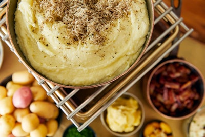 Mashed potatoes with toppings including smoked bacon, crème fraîche, chives, and Maldon sea salt