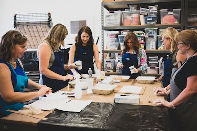 Attendees were given monogrammed smocks for the monoprinting and marbling activities.