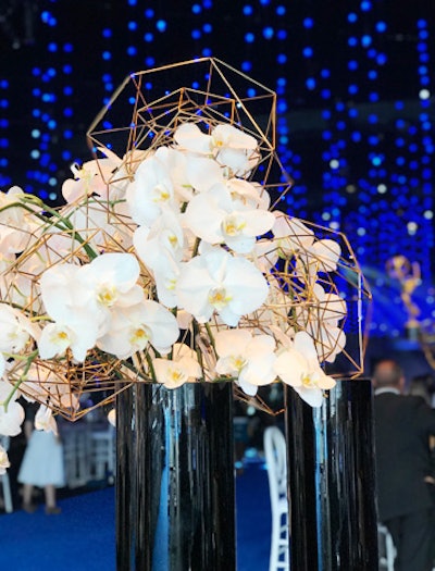 Large floral centerpieces will incorporate angular metals.