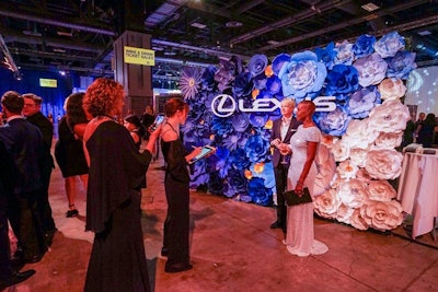 Guests posed in front of a wall covered with 3-D flowers from Lexus. Walton Isaacson also led the activation for Lexus, with production help from Living Color Design.