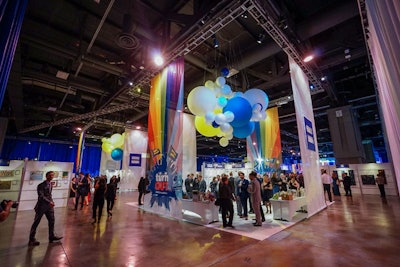 Guests perused the silent auction items in two different square areas, set off by rainbow 'TurnOut' signage and oversize balloons.