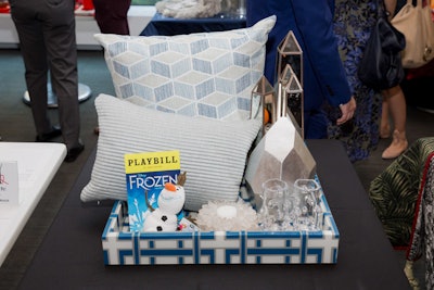 Drawing inspiration from Frozen, a basket designed by home fashion brand Kravet Inc. features mirrored obelisks and spiked vases to imitate icicles and a silver-toned sculpture to evoke a glacier.