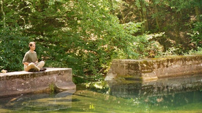 Meditating by pond