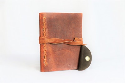 Handcrafted leather journal with a cord taco provides 3 days of schooling for children in Honduras