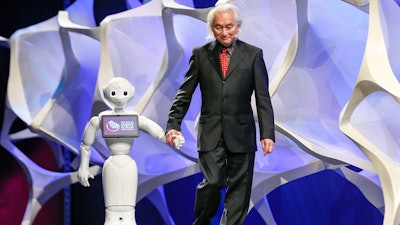 Futurist & Theoretical Physicist Dr. Michio Kaku walks on stage with Pepper the robot at the World Science Forum.