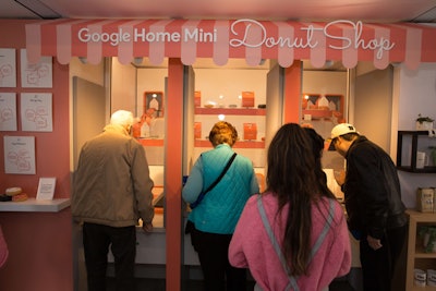 The first floor of the C.E.S. activation had a Google Home Mini Donut Shop. At a kiosk, visitors were able to ask the Mini a question, which triggered a box to slide down a chute. The box either contained a doughnut or a Mini.