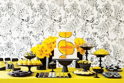 For the launch of Pilates NYC's pre- and post-natal programs, Amy Atlas designed a monochromatic table with yellow flowers, artwork, cupcakes, and other treats.