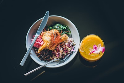 The Assemblage NoMad in New York serves up Ayurvedic dishes in its ground-level café, which change based on the season to feature local ingredients at peak potency—the basic principle of an Ayurvedic diet. Items include togarashi-roasted chicken with stormy lentils, gomae spinach, yuzu cabbage slaw, and house-pickled red cipollini onions (pictured); steel-cut oatmeal with cranberry compote, spiced apples, pepitas, chia seeds, and organic maple syrup; and various elixirs. The co-working venue also offers various spaces that are available for private events, and the staff can custom design teambuilding workshops and programming including wellness and movement classes for groups.