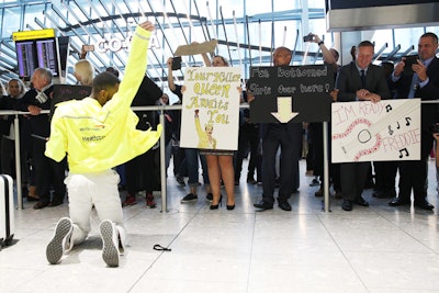 The back of the jackets featured the British Airways logo. Travelers in the Terminal 5 baggage claim were given hand-drawn fan posters to hold.