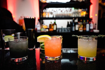 Guests could choose food and cocktails from Contemporary Catering that matched the event's color scheme and tone. The event's signature cocktails were, from left: the Dark Lord, with Triple Sec, lime juice, simple syrup, and activated charcoal powder; the Familiar, with vodka, Triple Sec, cranberry juice, and orange juice; and Witches Brew, with gin, apple cider, honey simple syrup, and lime juice.