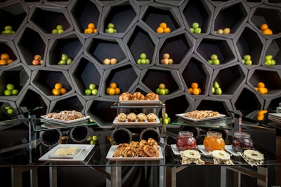 This breakfast pastry setup at the Anaheim Marriott features an Instagram-worthy honeycomb-inspired backdrop with citrus fruits.