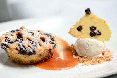Greig Farms blueberry pie baked in a brown butter lattice crust, served with ginger ice cream, a dried blueberry white chocolate shard, and coconut caramel sauce, by Abigail Kirsch Catering in New York