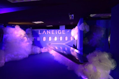 Cosmetics brand Laneige's purple space has a life-size portion of a plane; guests can take photo ops standing on the wing or sitting in airline seats.