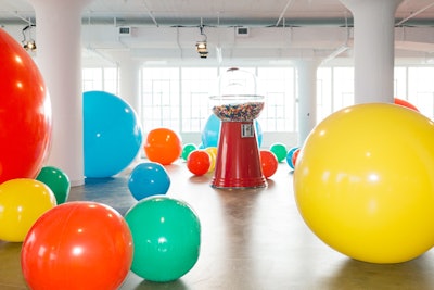 Installations include a giant gum ball machine surrounded by oversize beach balls.