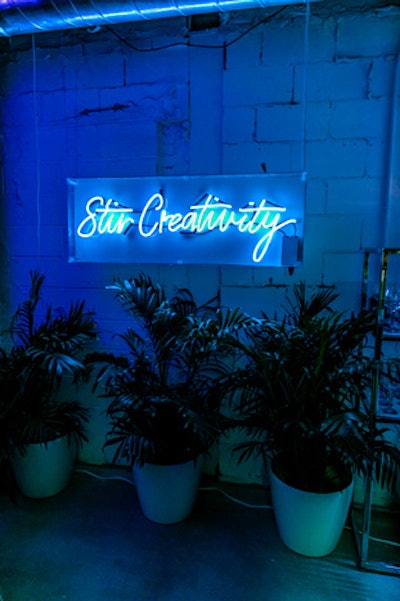 'Stir Creativity,' the name of Bombay Sapphire's campaign that encourages consumers to unleash their creative side, is displayed in blue neon signage. The tagline is also the pop-up's hashtag on social media.