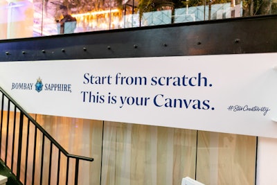 A sign in the entrance of the pop-up informs guests about the pop-up's creativity theme, with the glass serving as a blank 'canvas.'