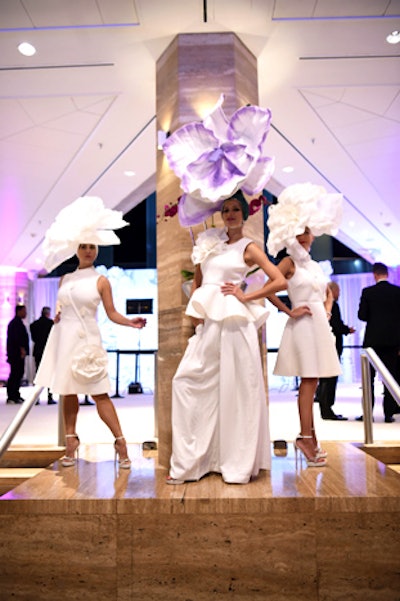 Other entertainers wore white gowns with oversize floral headpieces.