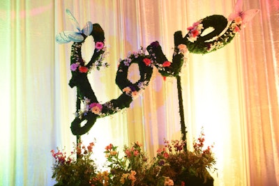 A cursive 'Love' topiary was decorated with flowers and faux butterflies.