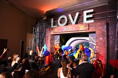 In what has become a tradition for the ball, guests were gathered and led into the hotel’s grand ballroom with an artistic performance. This year, a group of dancers waving colorful streamers ushered in guests to the song “Age of Aquarius,' from the 1967 musical Hair. The door opened to a tunnel of psychedelic colors, which led to the ballroom for the dinner portion of the event.