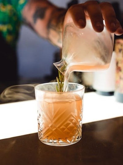American restaurant chain Eureka! has introduced a new cocktail called Your Highness. The cocktail features gin, rosemary, grapefruit, aperitivo, and Grand Hops Amaro, topped with smoked citra hops.