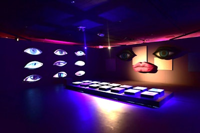 One of the more memorable and surreal spaces includes a wall featuring videos of blinking eyes, and a platform resembling a makeup palette.