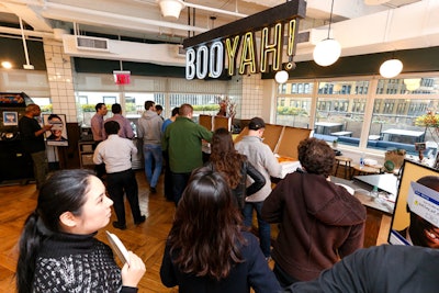 Free pizza was served under a neon 'Booyah!' sign, calling back to a phrase in '90s slang lexicon.