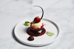 Dessert is gluten-free, pistachio cream cheese ivory made with flourless chocolate, vanilla kirsch genoise and cream cheese, and a Charlotte pistachio center.