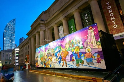The 40-by-20-foot mural depicts a holiday scene in Toronto, with classic Lego figures, a hockey player with a candy cane, and animals including a moose and a beaver.
