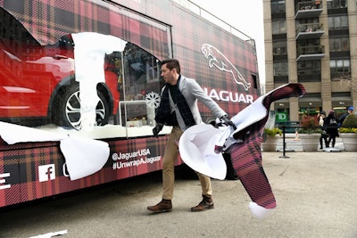 About 900 square feet of vinyl tartan wrap covered the Plexiglass display windows, which Scott happily ripped away as part of the reveal. 'This was the most playful interpretation of our ‘Unwrap a Jaguar’ campaign ever,' said Schorr. The bus will be traveling around Manhattan through December 23.